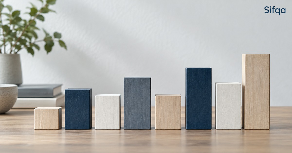 Wooden and navy blocks of varying heights lined up on a table like a bar chart.